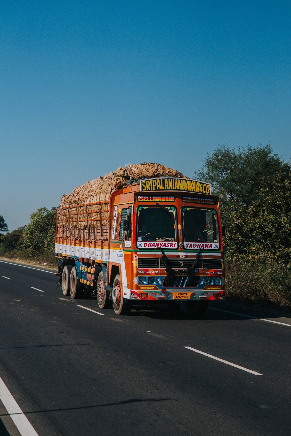A loaded Indian goods truck driving on an open highway